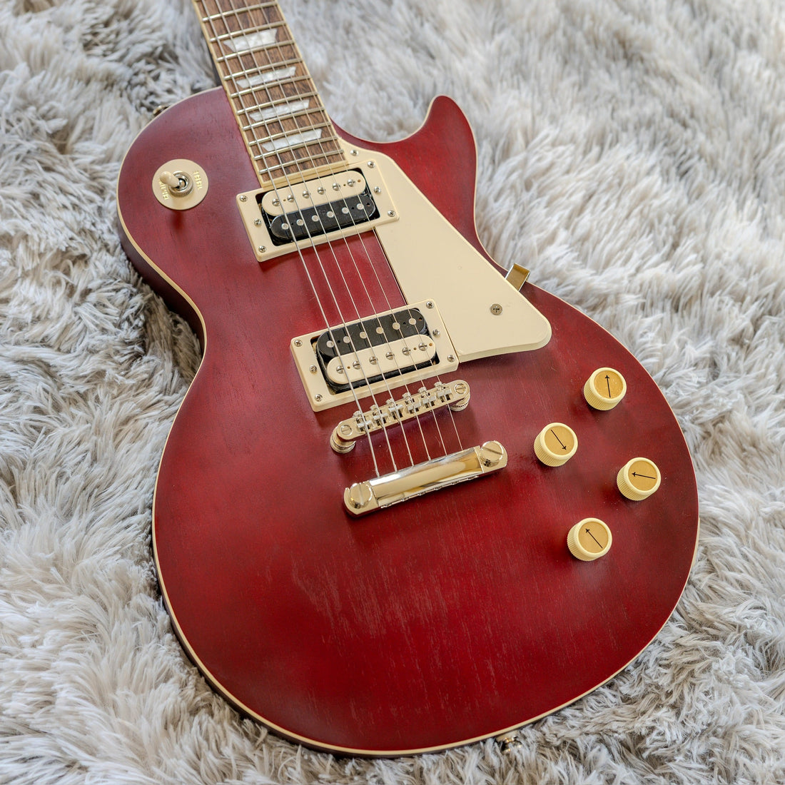 Used Epiphone Les Paul in worn wine red, a mid-tier electric guitar that makes a strong first guitar for a beginner
