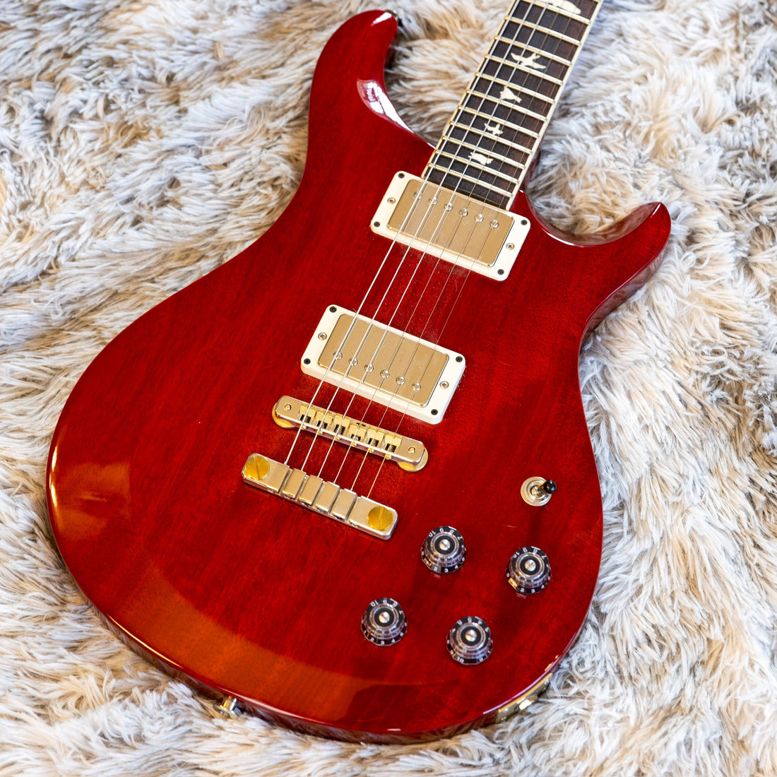 Close-up of the control layout on a PRS S2 McCarty 594, whose two tone knobs are push-pull pots used to coil-tap each humbucker