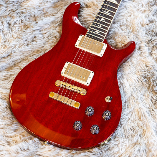 Close-up of the control layout on a PRS S2 McCarty 594, whose two tone knobs are push-pull pots used to coil-tap each humbucker