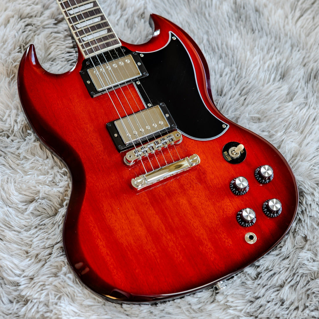 Gibson SG Standard in cherry burst — a thin, light body and long neck make it the classic neck-dive guitar.