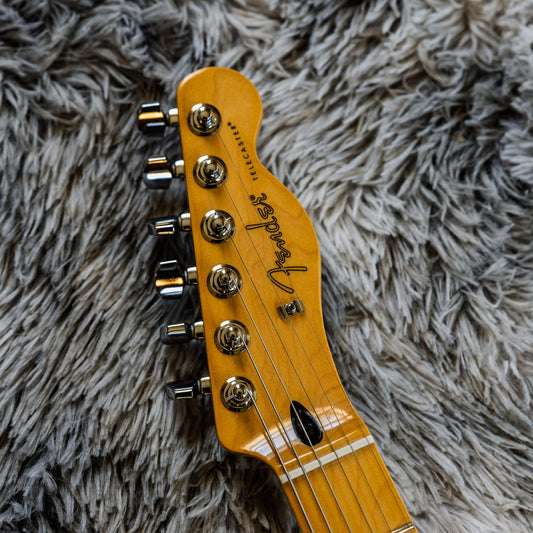 Front of a used Fender Telecaster headstock with standard vintage-style tuners and a string tree, on the Aeonic Frets bench.