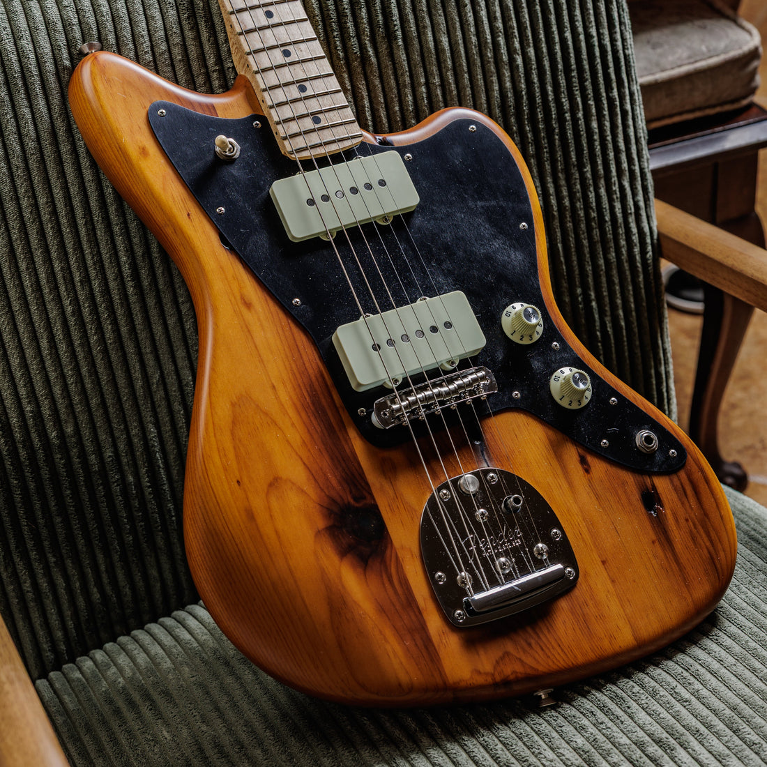 Fender Jazzmaster in natural pine finish showing the wide flat single-coil pickups and offset body