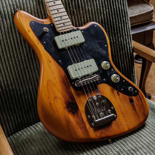 Fender Jazzmaster in natural pine finish showing the wide flat single-coil pickups and offset body