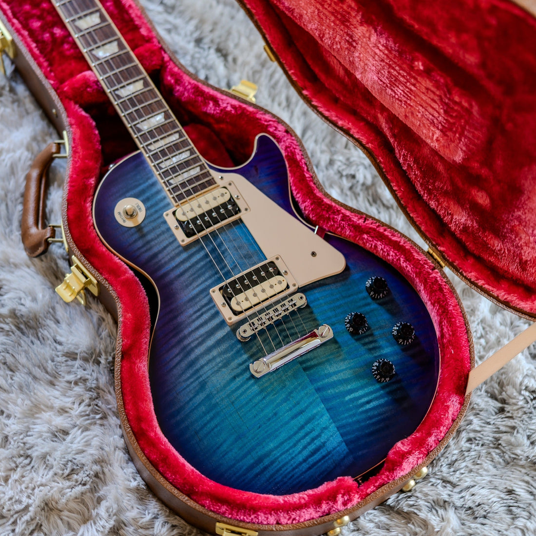 Gibson Les Paul Traditional Pro V in Blueberry Burst in an open case, illustrating unit-to-unit variation between identical guitar models.