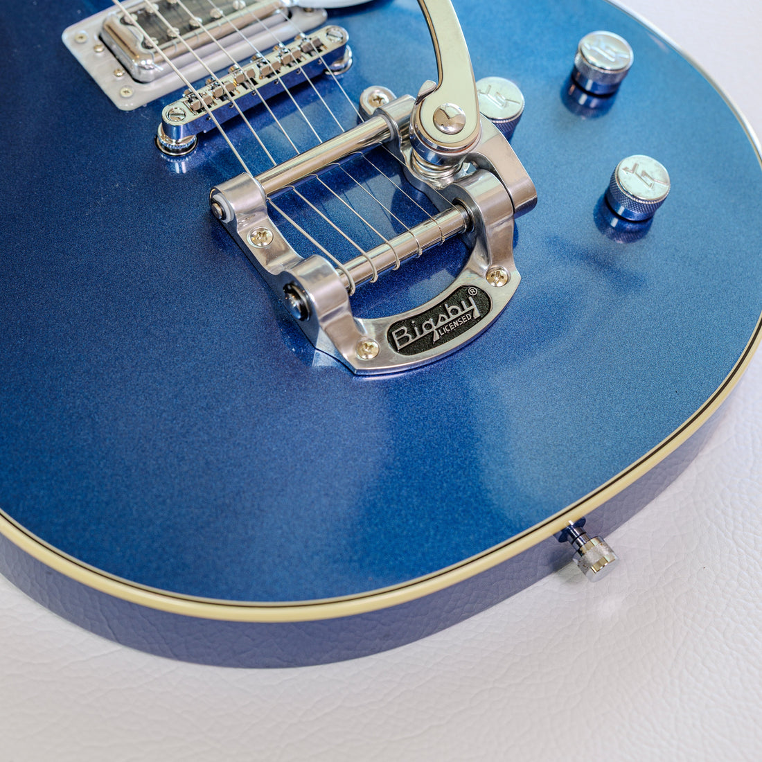 Close-up of a Bigsby vibrato tailpiece and tune-o-matic bridge on a Gretsch Electromatic Double Jet FT