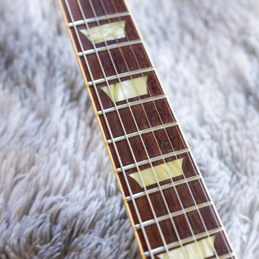 Close-up of a used Gibson Les Paul rosewood fretboard showing frets with height remaining