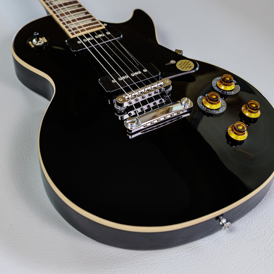 Black single-cut Gibson Les Paul with two black soapbar P-90 pickups
