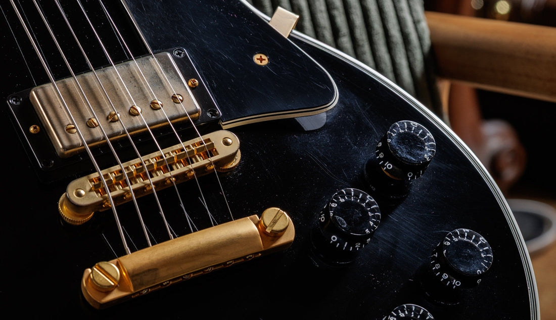 Volume and tone control knobs on a Gibson Les Paul Custom, the tops of its four potentiometers