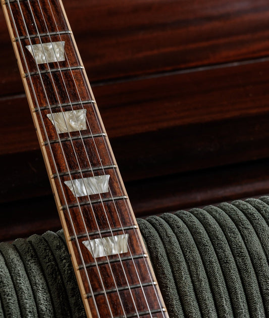 Bound rosewood fretboard on a 2016 Gibson Les Paul Traditional with binding nibs capping each fret end