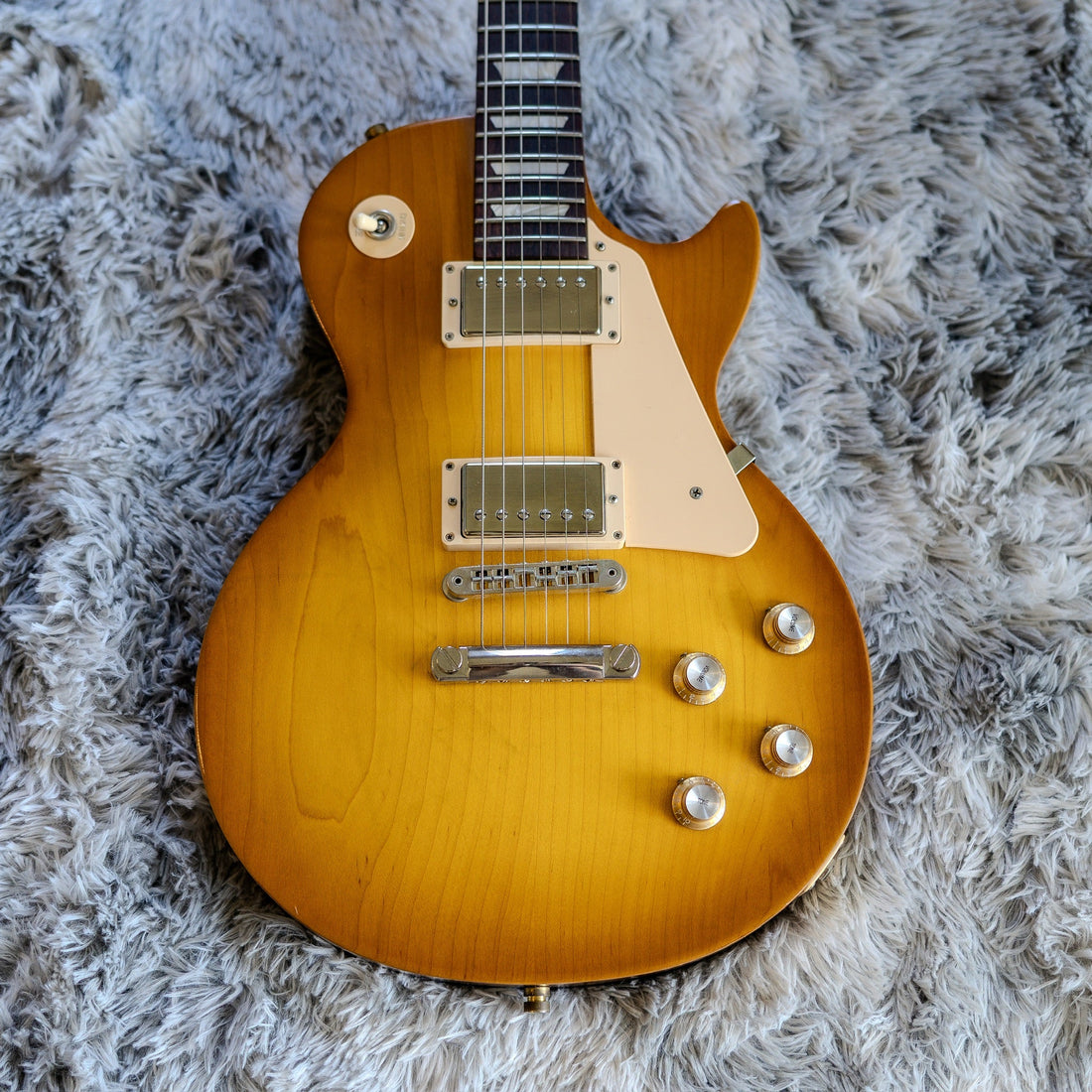 Gibson Les Paul Tribute T in Faded Honey Burst with a satin nitrocellulose finish and covered humbuckers