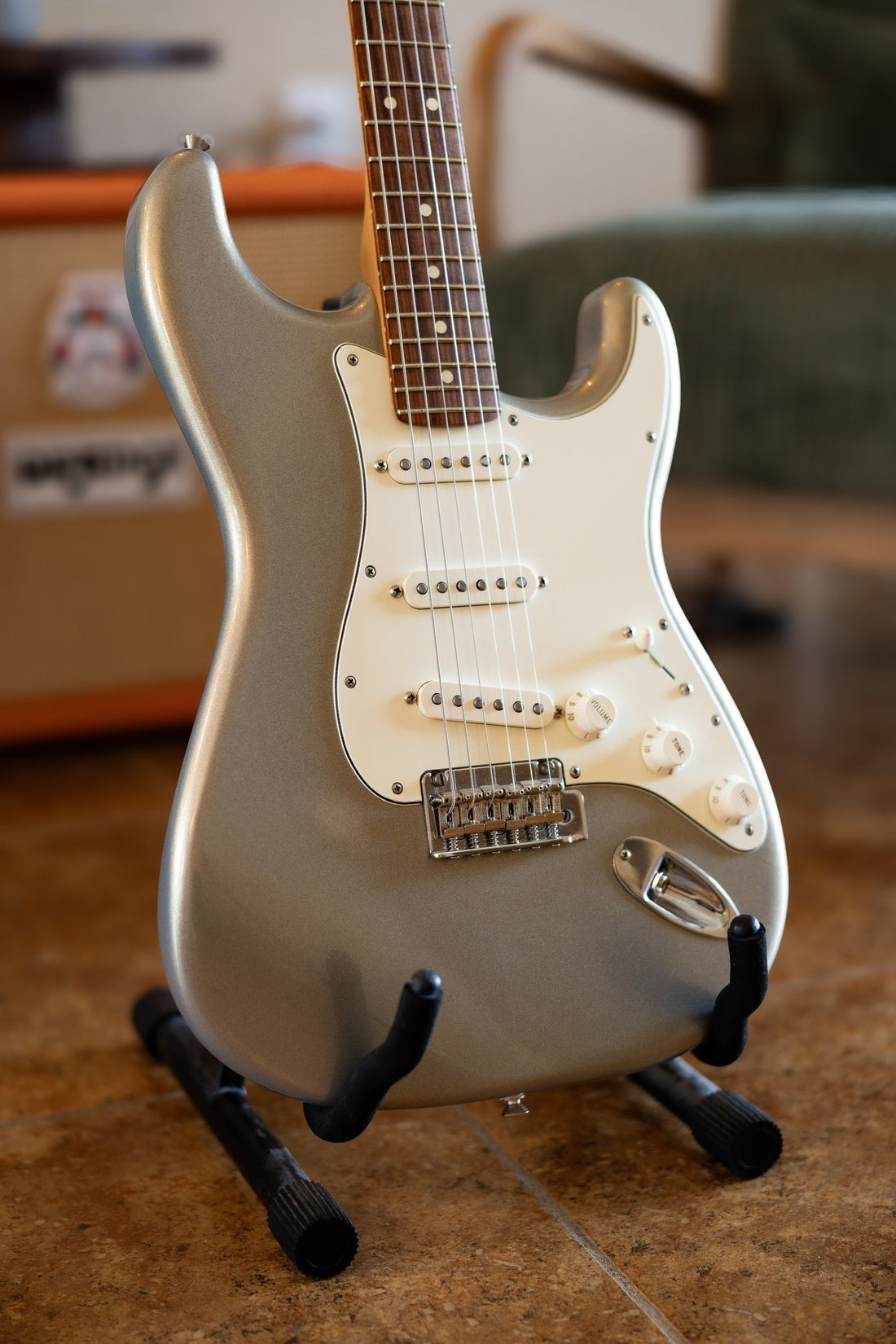 Fender Player Stratocaster in Silver with pau ferro fingerboard and parchment pickguard on a guitar stand