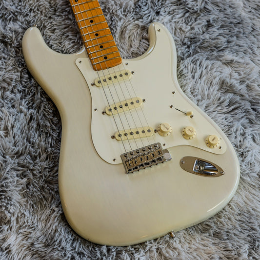 Fender Eric Johnson Stratocaster signature model in White Blonde on a used-guitar shop bench