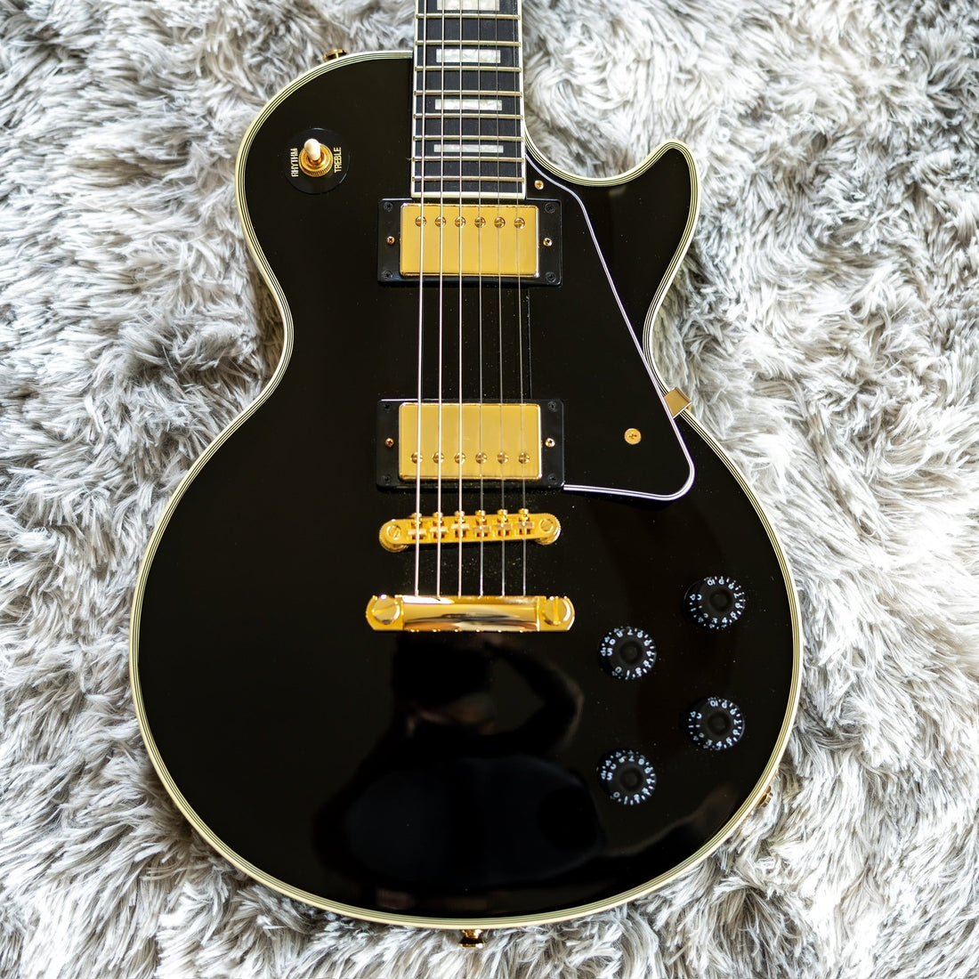 Modern Chinese-made Epiphone Inspired by Gibson Les Paul Custom in ebony, representing the post-2020 Epiphone build
