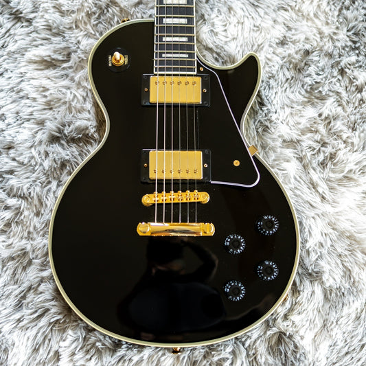 Modern Chinese-made Epiphone Inspired by Gibson Les Paul Custom in ebony, representing the post-2020 Epiphone build