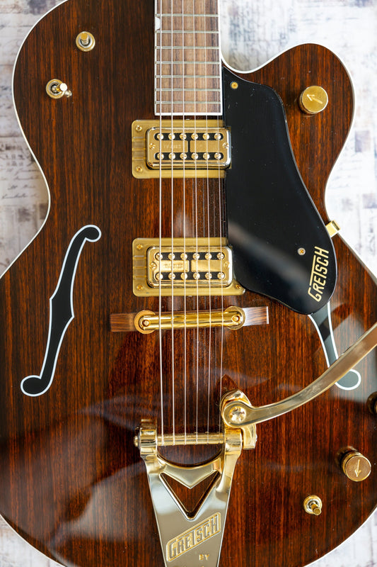 Fresh gold hardware on a Gretsch archtop — bright gold humbucker covers, Bigsby tailpiece, bridge and knobs before any wear.