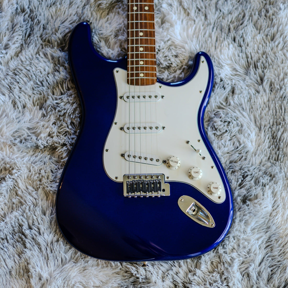 Used Fender Standard Stratocaster in Midnight Blue, full front view on a grey blanket