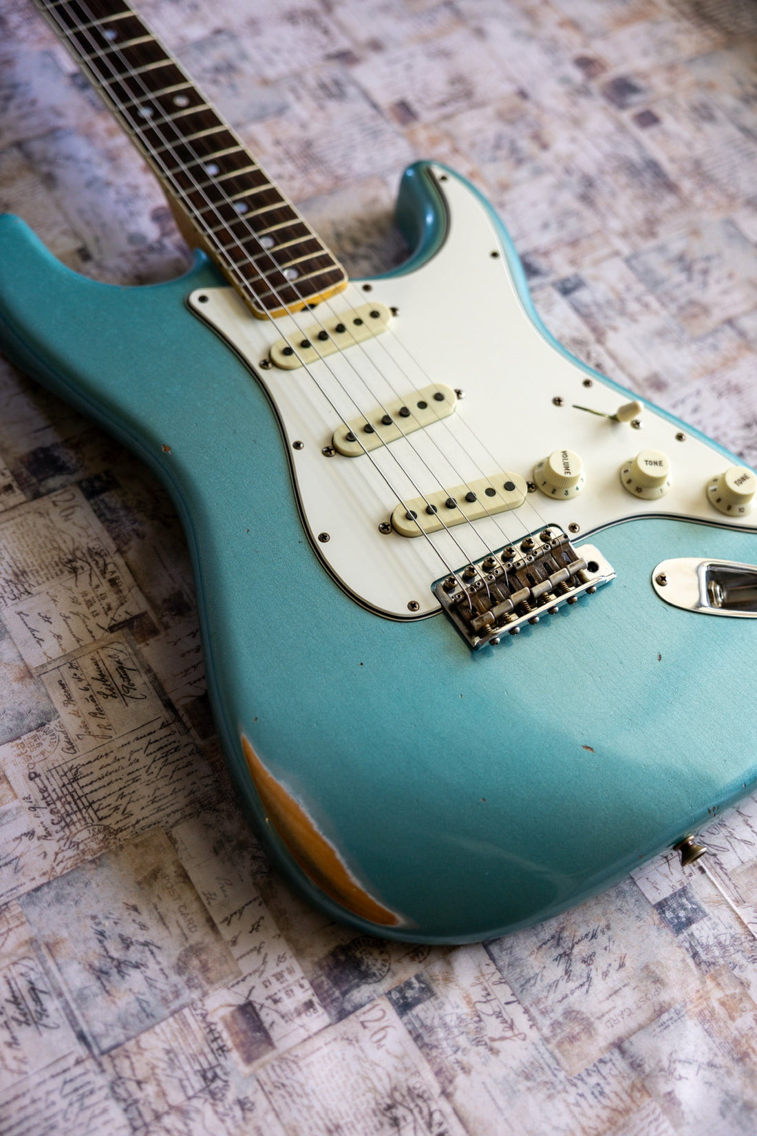 Fender Custom Shop '67 Reissue Stratocaster Relic showing lower bout finish wear through to the wood and aged bridge saddles